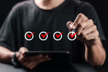 checklist concept, person using pen checking mark on checkboxes on virtual screen.
