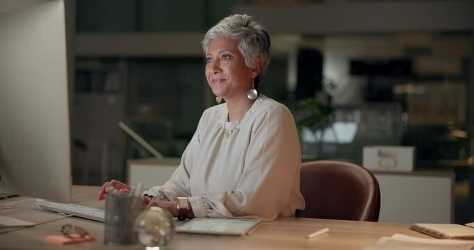 Mature woman, office and night with computer for research or typing email as human resources manager. Female person, happy and smile with information on tablet for employee contract or agreement