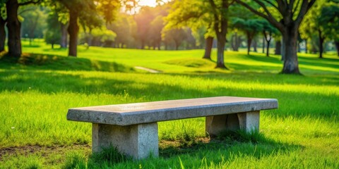Naklejka premium Stone bench on green grass in a peaceful park setting, bench, stone, park, lawn, rest, relaxation, nature, outdoor, tranquil