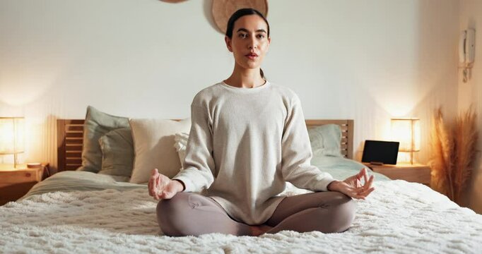 Calm woman, bed and yoga with meditation for zen, awareness or spiritual wellness at home. Young, female person or yogi in relax or lotus pose for exercise, health and wellbeing in bedroom at house