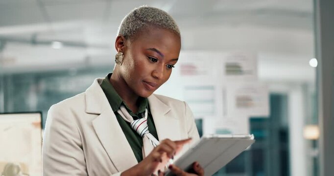 Business, black woman and typing on tablet in office at night for email feedback, project research and corporate deadline. Professional, finance employee and overtime on digital tech with planning