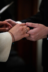 Obraz premium Male and female holding hands during a wedding ceremony.