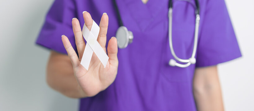 Stop Violence Against Women and November Lung Cancer Awareness month. Doctor with White ribbon in hospital. Healthcare and World Cancer day concept - Powered by Adobe