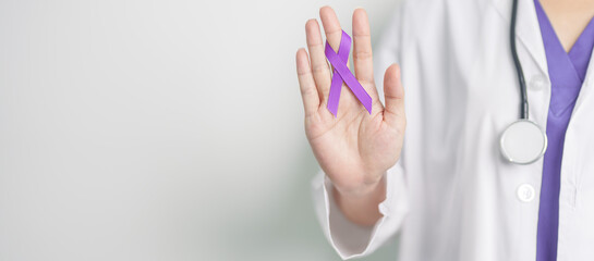 Doctor holding purple Ribbon for Violence, Pancreatic, Esophageal, Testicular cancer, Alzheimer,...