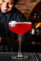 Elegant deep red cocktail made with rum in a luxurious bar in Colombia.