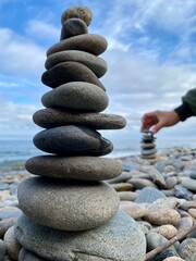 A pyramid of stones on the shore of Lake Baikal, a place of power, the soul of a pilgrim
