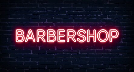 Fototapeta premium Barbershop word lettering glowing with neon light on dark brick wall background