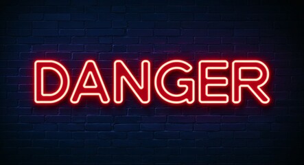 Obraz premium danger word lettering glowing with neon light on dark brick wall background