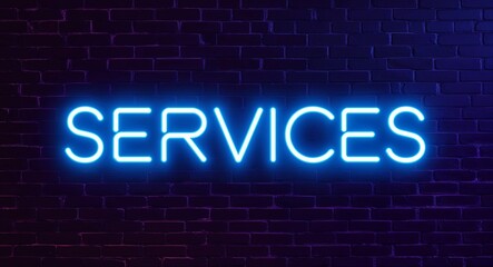 Obraz premium Services word lettering glowing with neon light on dark brick wall background