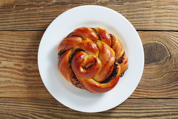 Bun with chocolate in a plate