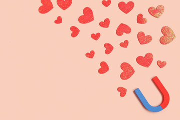 Magnet with paper hearts on beige background. Love concept