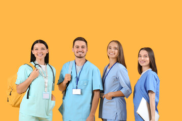 Group of medical students on yellow background