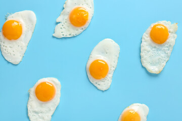 Fried quail eggs on blue background