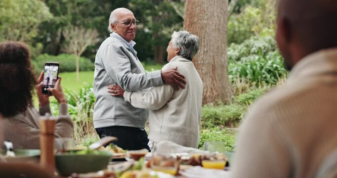 Senior, couple and dancing in garden with marriage at family reunion for celebration with fun. Happy woman, home and smile with social media post, care and love at anniversary party and event
