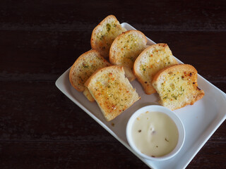 Delicious garlic bread at a cafe on a wooden table        