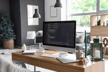 Interior of office with programmer's workplace decorated for Christmas