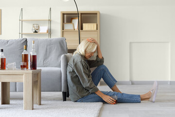 Drunk mature woman at home. Concept of alcoholism