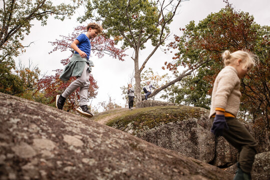 Kids exploring large boulders on an autumn hike in Missouri