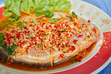 Deep fried snapper with sweet chili sauce in plate