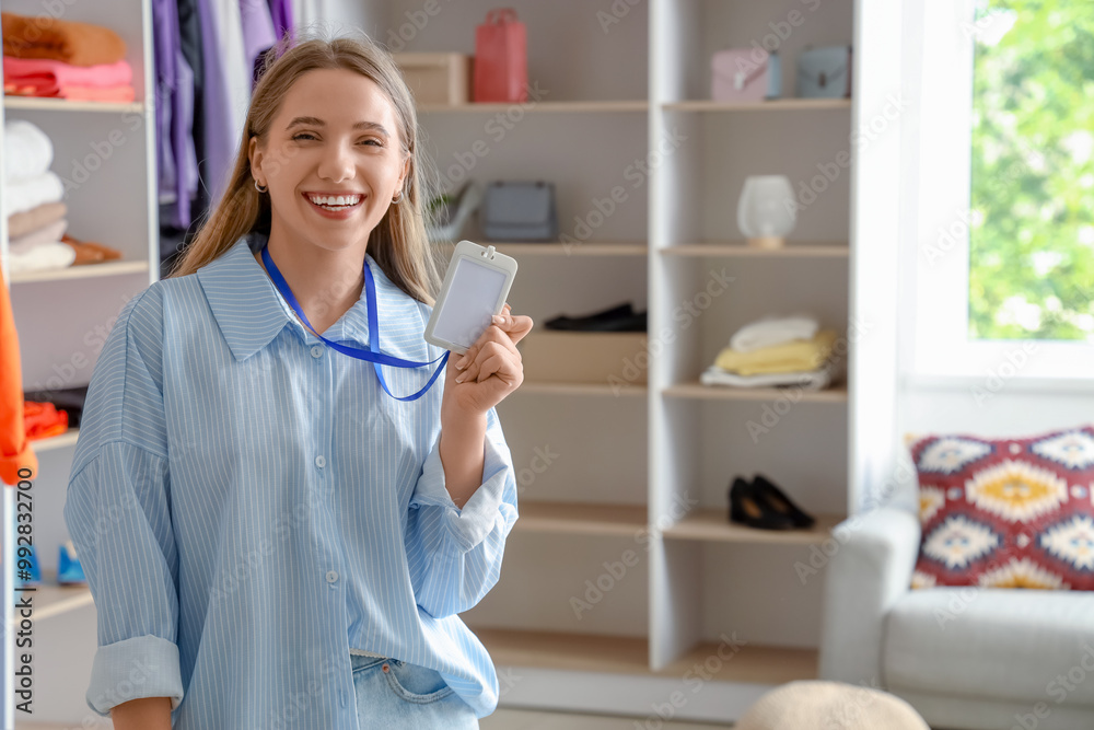 Poster Female seller with badge in clothing store