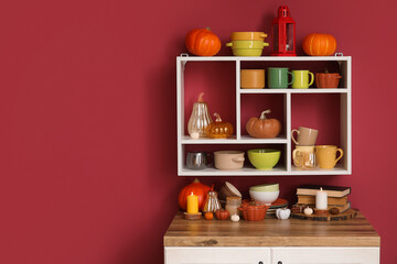 Stylish interior of kitchen with dishes and beautiful autumn decor