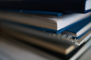 Stack of magazines, books, papers in the office.