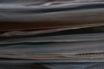 Stack of magazines, books, papers in the office.