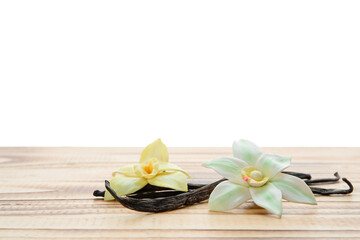 Aromatic vanilla pods and flowers on table against white background