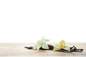 Aromatic vanilla pods and flowers on table against white background
