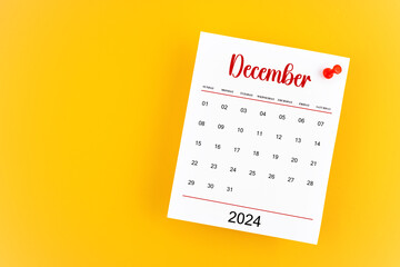 December 2024 calendar page with red push pin on yellow background.