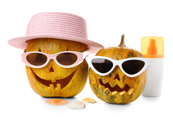 Halloween pumpkins in sunglasses and hat with sunscreen cream isolated on white background