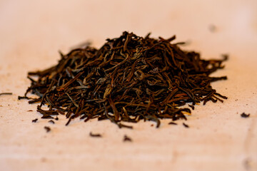 A handful of black tea lies on the table