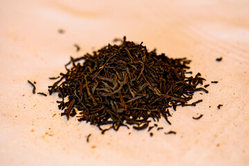 A handful of black tea lies on the table