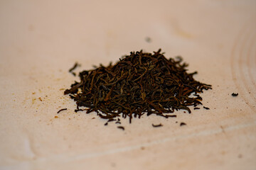 A handful of black tea lies on the table