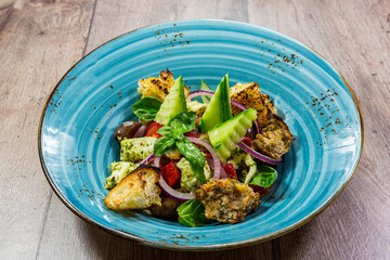 delicious fresh salad. salad with tomatoes, cucumbers and other vegetables with toasted bread and looking great.