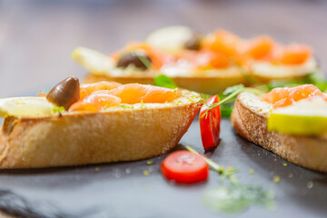 bruschetta with fresh vegetables and fresh meat. 
