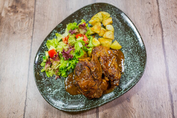 a plate with a beautiful meat dish and cooked vegetables. 