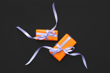 Halloween gifts on black background. Top view