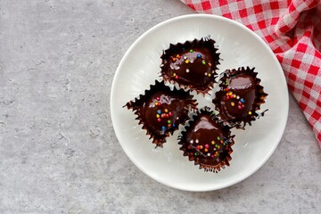 Chocolate Cake Balls in white plate on grey background
