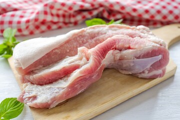 fresh pork belly on cutting board, raw pork belly