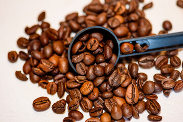 A pile of coffee beans spilled on the table