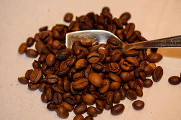 A pile of coffee beans spilled on the table