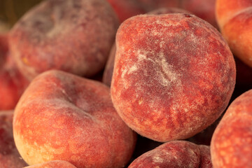 a pile of ripe washed peaches on the table