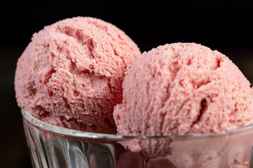 red strawberry-flavored ice cream in a glass bowl