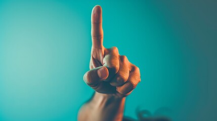 A man making a finger-up gesture with his hand, embodying optimism and a sense of achievement in a lively and engaging moment