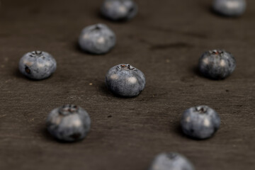 blueberries scattered on a black slate board