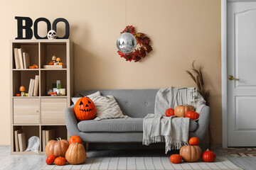 Stylish living room with disco ball and soft sofa decorated for Halloween party