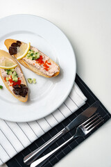 Tasty open-faced sandwiches with tuna spread, topped with fresh vegetables