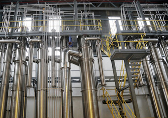 A complex network of pipes and vessels in a modern chemical processing facility.