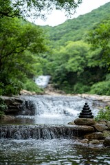 A Serene Waterfall Surrounded By Lush Greenery. The Calming Sound Of Water Adds To The Stress-Free Atmosphere